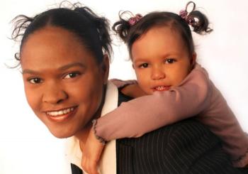 minority working mom with daughter happy